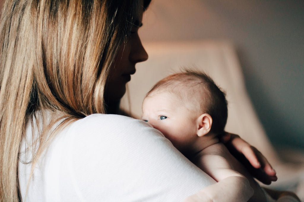 Woman holding a newborn baby