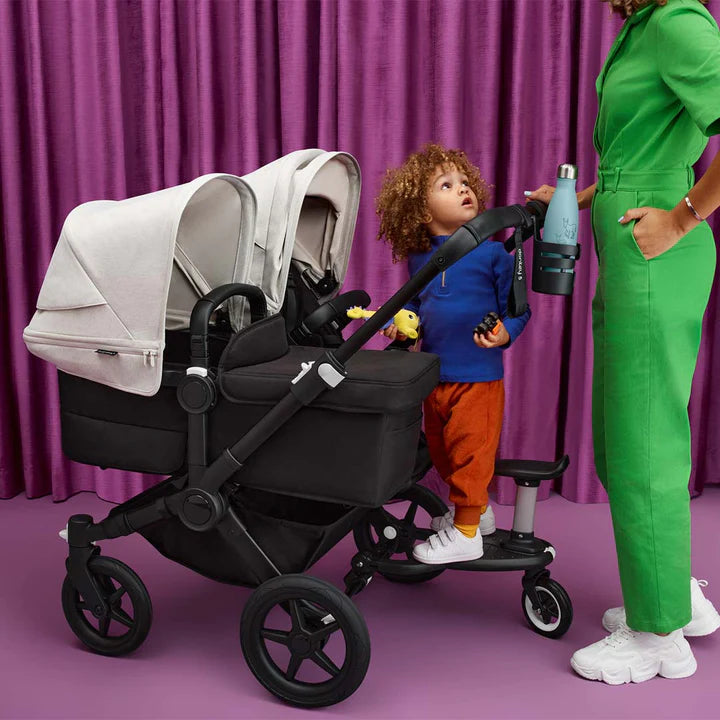 best strollers for twins and multiples - family with two babies and toddler on bugaboo donkey 5 stroller